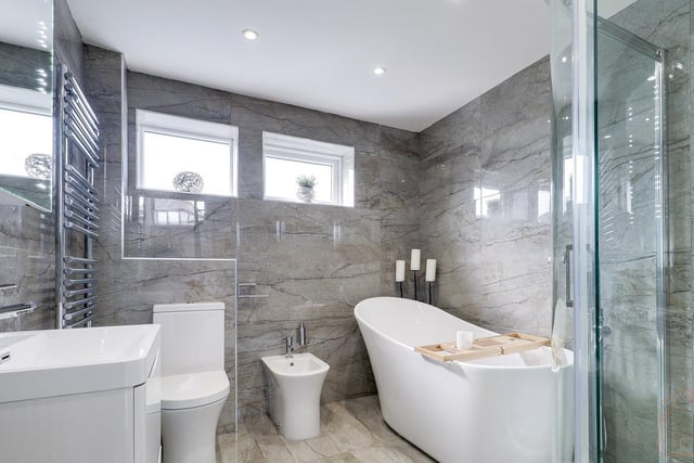A walk in shower and deep bath tub feature in this very stylish bathroom.