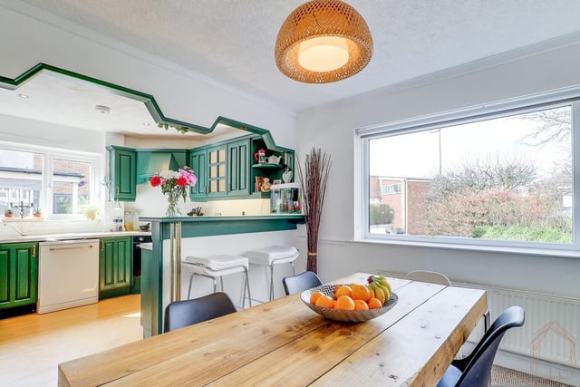 A light and airy open plan kitchen with fitted units, a breakfast bar, and diner.