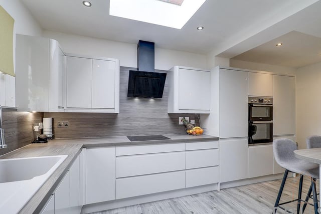 Fitted units witout handles, and integrated appliances are within the light and roomy kitchen.