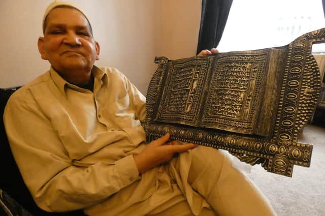 Mohammad Nazir, of Heckmondwike, holding a 1970s wooden engraved inscription of verses from the Koran