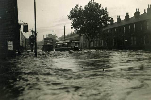 SAVILE ROAD: Two buses struggle through the flood water at the height of the 1946 flood as they try to make their way back to the depot on Mill Street East