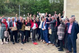 Labour members and councillors celebrate after winning a majority on Kirklees Council