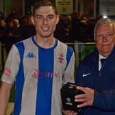 Ben Atkinson is presented with his trophy after being chosen as the man of the match in Liversedge FC’s West Riding County Cup final victory over Brighouse Town. Picture: Paul Butterfield