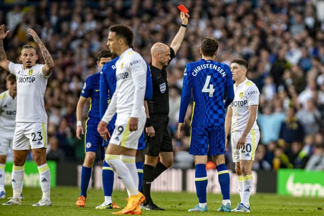 Dan James is shown a red card by referee Anthony Taylor to the despair of Kalvin Phillips.