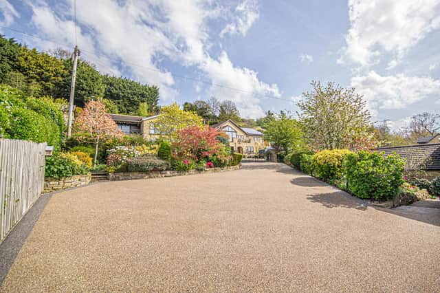 A newly laid drive with colourful borders leads up to the bungalow for sale.