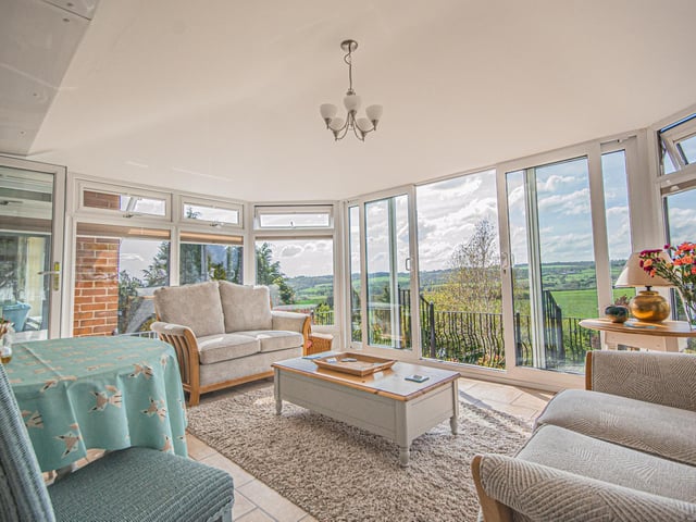 This conservatory is a perfect place to sit back and enjoy the extensive views.