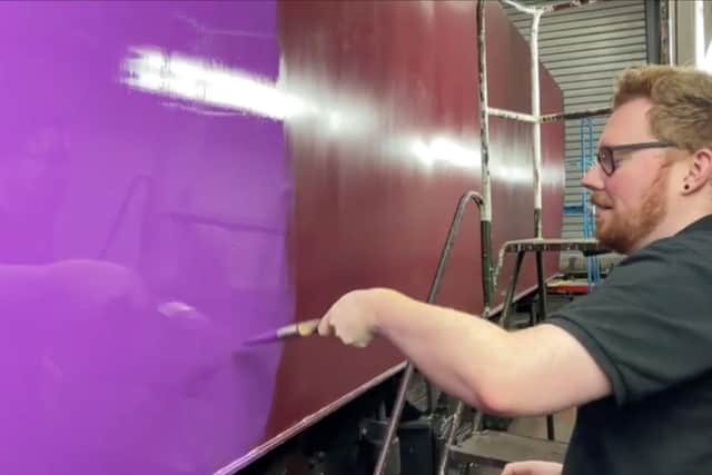 The train being given its purple paint job