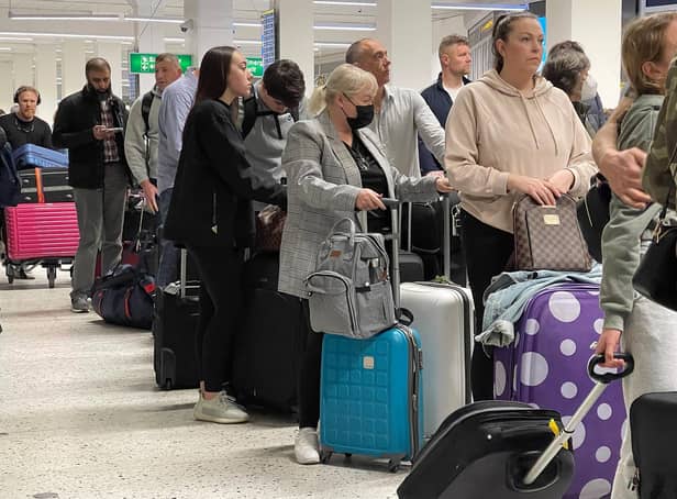 Passengers queue for check-in at Manchester Airport. Photo: Getty Images