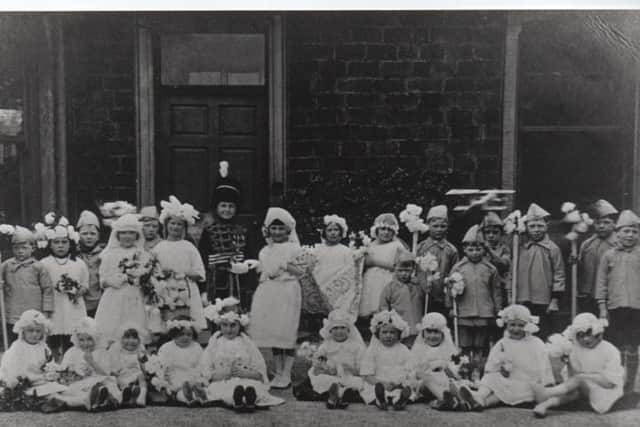 WHIT WALK: Thousands of people crowded the streets of Ravensthorpe to watch these little children of Ravensthorpe Wesleyan Methodist Church taking part in a Royal ‘mock’ wedding, held on Whit Monday some time in the 1930s