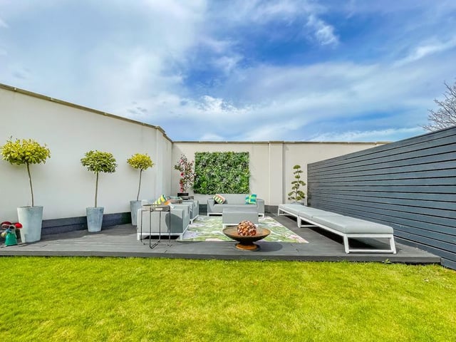 Stylish outdoor seating space that is sheltered on three sides is perfect for entertaining.