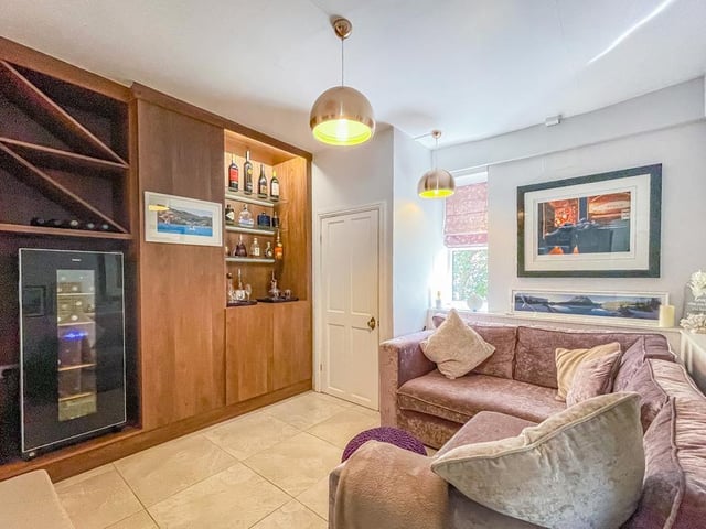 The snug is designed as a small, relaxing space with a built-in bar and added features.