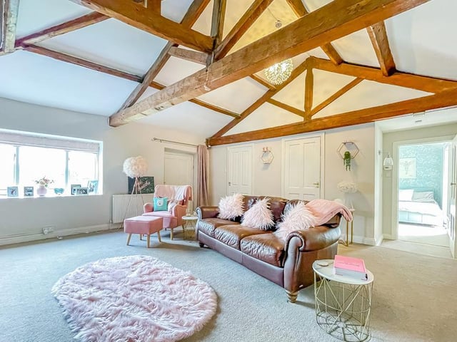 Versatile rooms include this one with open vaults and beams.