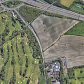 An aerial view of the proposed Amazon warehouse site at Scholes, near Cleckheaton, showing its proximity to local houses. It is bordered by the M62 on one side, a cemetery, Whitechapel Road and Whitehall Road
