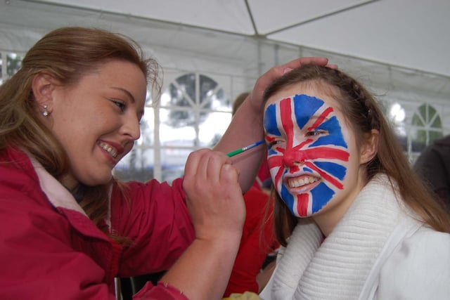 Charlotte Dentson has her face painted by Sandra Hall.