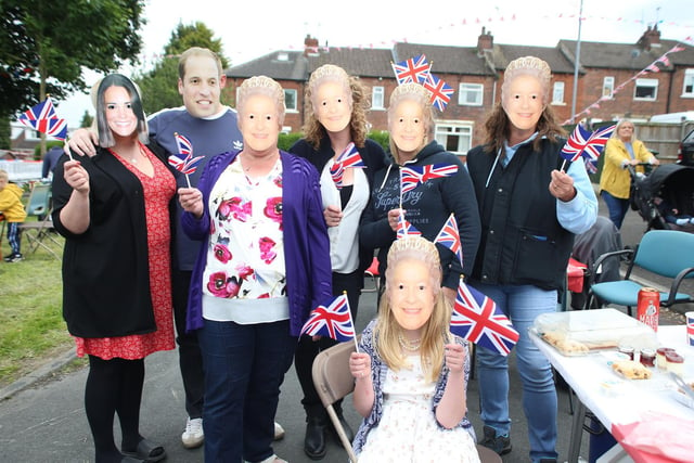 Residents of Cornmill Drive in Liversedge wear masks of the Queen, William and Kate, as more than 140 neighbours gathered for a street party