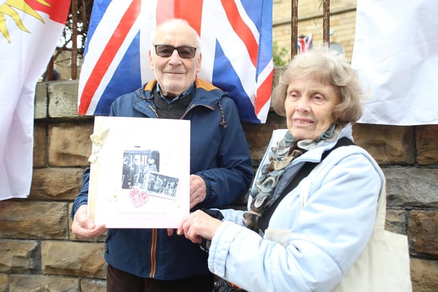Patrick Mitchell and Barbara Kilpatrick holding a tribute to the Dewsbury Reporter 1977 Silver Jubilee Card. This one was made by UK Greetings in Dewsbury and is from all the people of Dewsbury to celebrate the Queen's Platinum Jubilee
