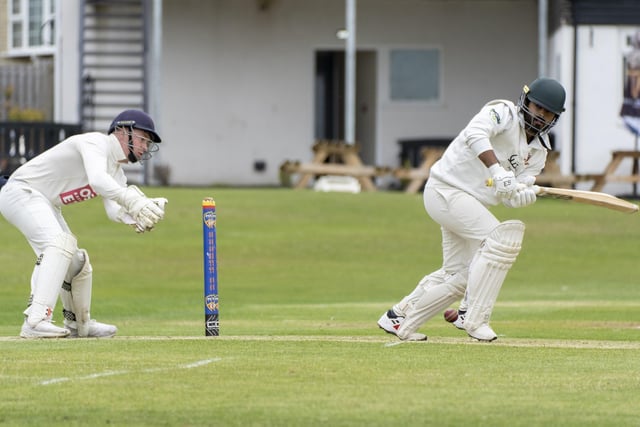 Ossett wicketkeeper Sam Storr is ready to pounce as Yousaf Baber bats. Picture: Scott Merrylees