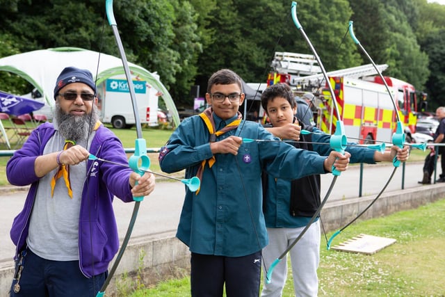 Yusuf Patel, Rayyan Hafez and Hasan Irfan with the scouts at the Great Get Together in Wilton Park, Batley