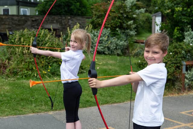 Lucas Giles and Poppy Telford, year three pupils doing archery.