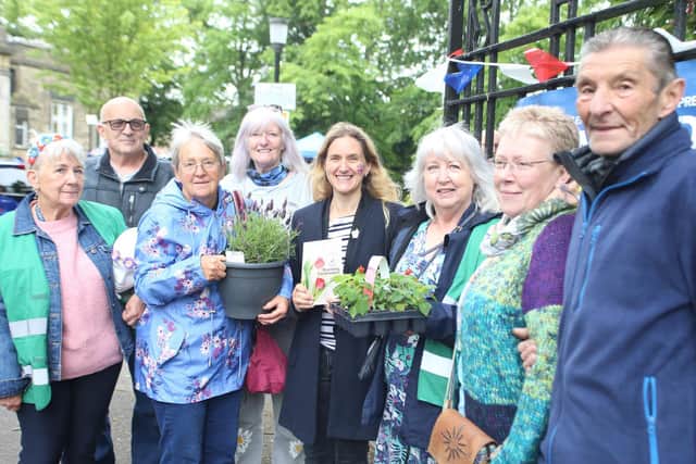 Cleckheaton in Bloom members pose with Kim at the gates of Cleckheaton Library during an event to celebrate the Queen’s Platinum Jubilee on June 4, 2022. Photo: John Bradley