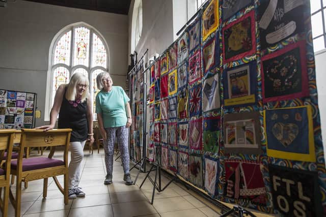 Lindsey Robertshaw and Ronalda Johnstone look at the Southport FTLOS Quilt.