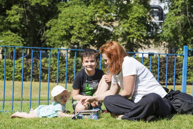 Enjoying the sunny weather at Crow Nest Park in Dewsbury are, from the left, Ivy Durber, eight months, Roman Durber, seven, and mum Charlotte Durber. Photos by Jim Fitton