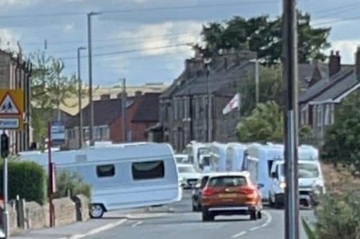 Travellers’ vehicles queuing on Old Bank Road in Mirfield as they wait to enter a recreation ground