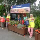 Some of the volunteers watering the plants at Mirfield train station.
