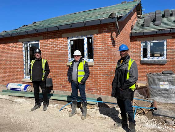 Wayne Noteman, Unity regeneration director (right) with Josh Paterson, Torpoint director (centre) and Mick Rogers, Torpoint site manager (left), outside one of the new Dale Lane properties which is nearing completion