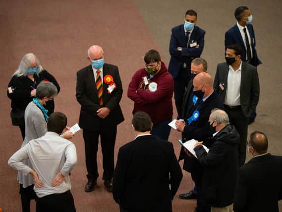 Candidates await the results at today's election count at Cathedral House in Huddersfield