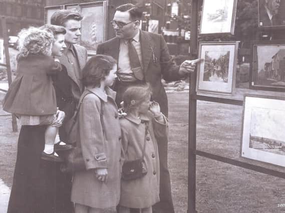 LONGCAUSEWAY: Mr Fred W Smith, former librarian and curator of Dewsbury Museum and Art Gallery, showing paintings done by local artists.