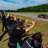 The inception team cheer on their driver at the International Raceway.