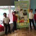 Children at Diamond Wood Community Academy, Ravensthorpe, with their floral-themed display