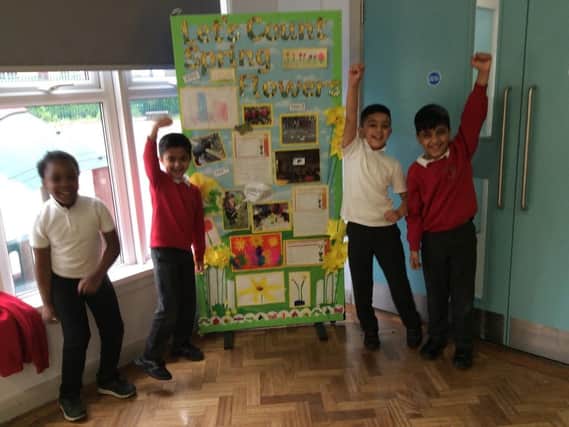 Children at Diamond Wood Community Academy, Ravensthorpe, with their floral-themed display