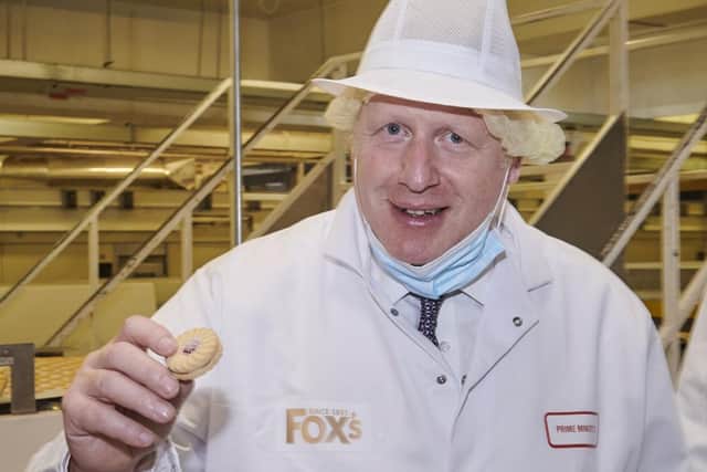 Mr Johnson was asked which biscuit is his favourite. He picked a jam and cream one. Photo by Joel Anderson
