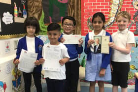 Children at St John's Infant School, Dewsbury with their card from the Queen