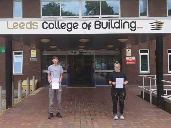 Leeds College of Building students, Ben Pratt and Zara Dupont, with their letters from care home residents in Birstall