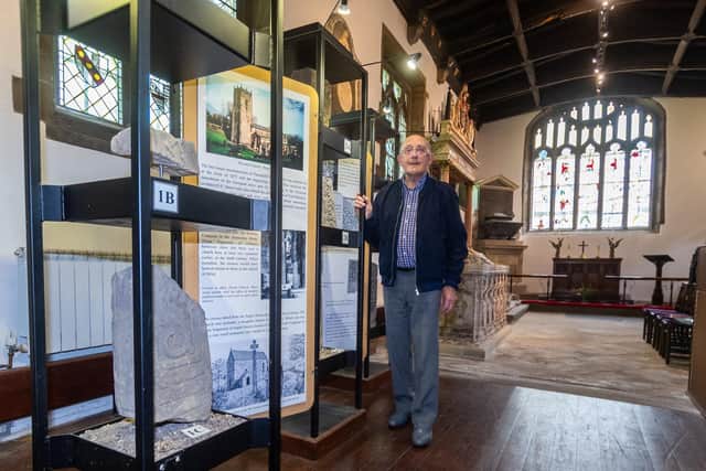 Mr Pearson next to many of the ancient monuments belonging to the church which are displayed within the chapel