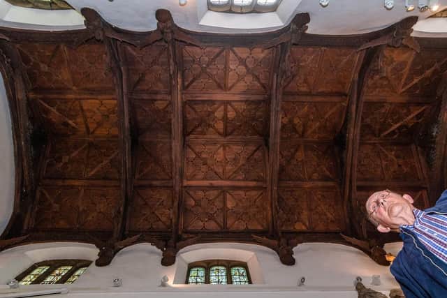 Mr Pearson looks at Thornhill Parish Church's ornate wooden ceiling, with wooden carved angels.