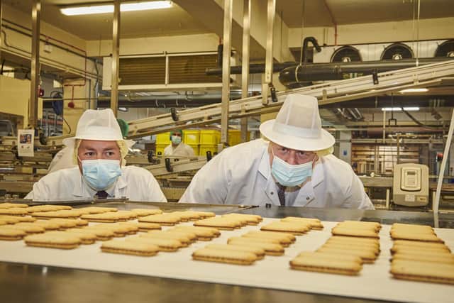 Prime Minister Boris Johnson with the Conservatives' by-election candidate Ryan Stephenson on a visit to the Fox's Biscuits factory in Batley. Photo: Joel Anderson