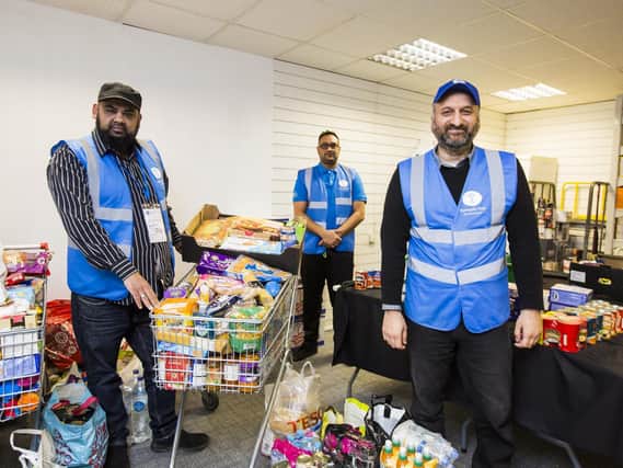 Pictured from the left are Idris Yousaf, Qumar Uddin and Arif Ahmad at Humanity First Food Bank in Mirfield.