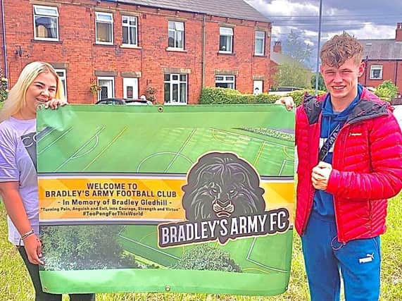 Bradley’s sister Bryony Gledhill and his childhood best friend Kenny Wall with the banner for the newly formed Bradley’s Army Football Club