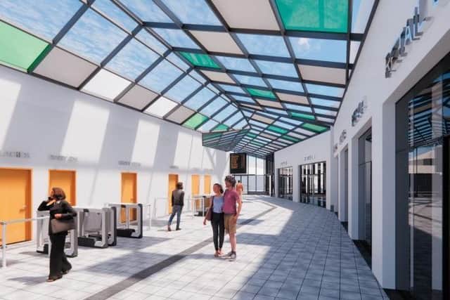 An artist’s impression of an interior corridor between Aldams Road and South Street passenger entrances, with glazed atrium roof and improved retail area