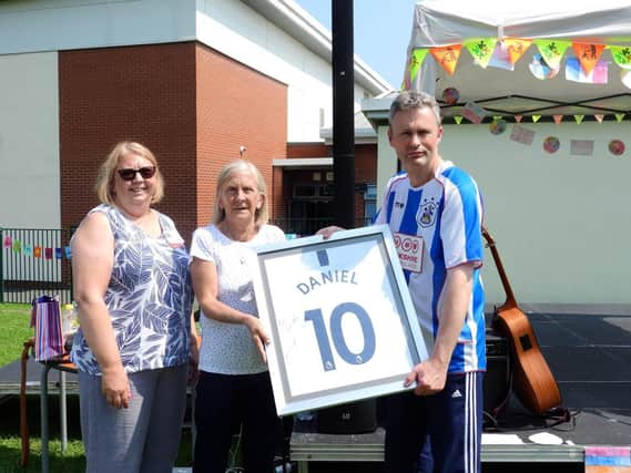 Daniel's auntie Ruth Coopland (left) with grandma Kim Sullivan and teacher Steve Garside with the signed shirt from England captain Harry Kane