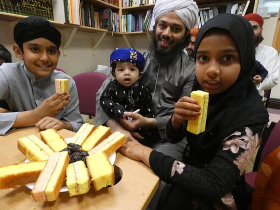 Local Imam and Nashid Poet, Muhammad Yasir Atthari from the Kanzul-Iman Jamia Mosque in Heckmondwike, with his children enjoying some cream cakes at the Albion Street place of worship.