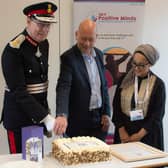 Lord Lieutenant Ed Anderson and Dewsbury MP Mark Eastwood, with Shaffia Khatun of SKY Positive Minds, cut a celebratory cake at a ceremony to receive the Queen's Award for Voluntary Service. Photo by SKI Photography
