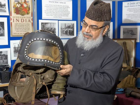 Professor Naeemi holding a Second World War infants gas mask when he visited the Ponderosa Past-Times Museum in Heckmondwike around ten years ago