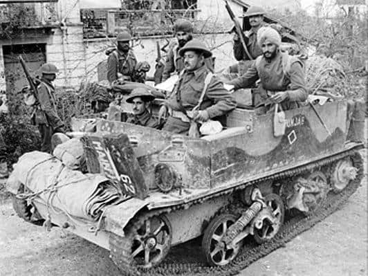 British-Indian Soldiers driving an armoured vehicle while in combat at Monte-Cassino in Italy