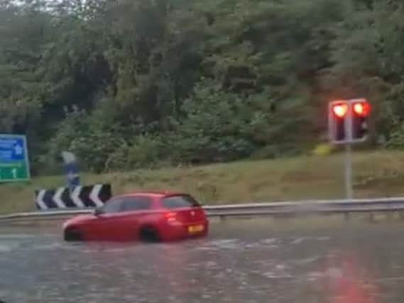 A car battles the flood water at Chain Bar roundabout