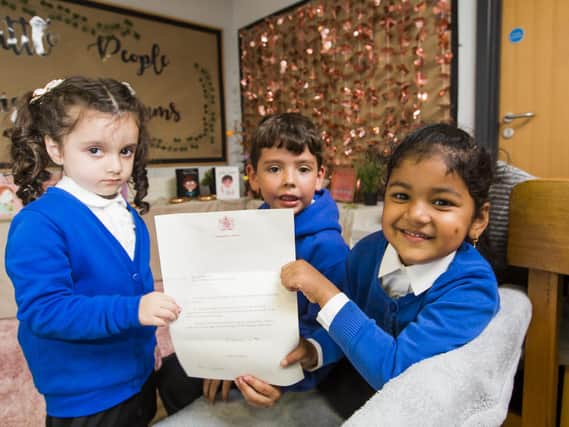 Youngsters at Boothroyd Primary Academy, Dewsbury with the letter from the Queen
